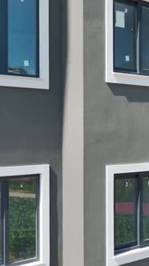Vertical Video Tall Building Under Construction Window Setting and Facade Finishing