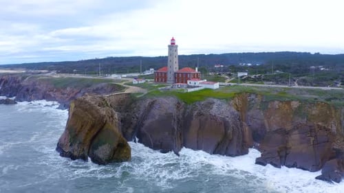 Aerial view of beautiful sunrise and light of the lighthouse.