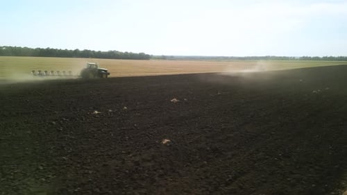 Tractors plowing the field in Ukraine