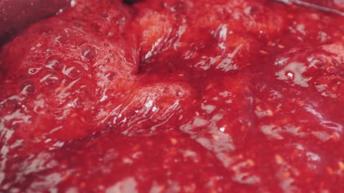 Bright Red Jam Bubbling in a Pan
