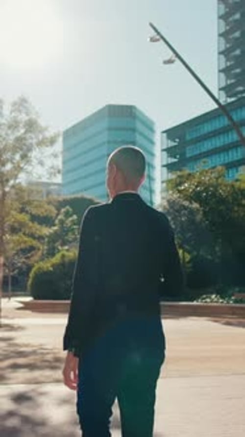 Vertical video, Businesswoman Walks Through City Park to Office