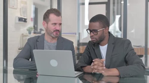 Businessmen Meeting at Desk with Laptop