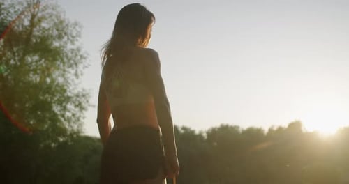 Young Woman Exercising Outdoors with Resistance Band