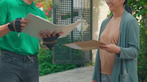 Delivery Man Delivers Package to Woman in Suburbs
