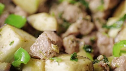 Chicken or Pork Stew with Red and Green Pepper Onion and Spices Cooking in a Frying Pan Traditional
