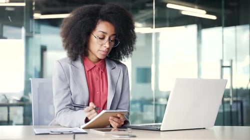 Confident Woman Working at Desk with Laptop