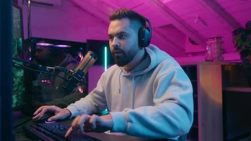 Smiling Gamer Playing Computer Game at Home