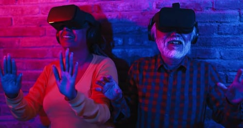 Multiracial senior friends explore the metaverse with augmented reality goggles in the USA