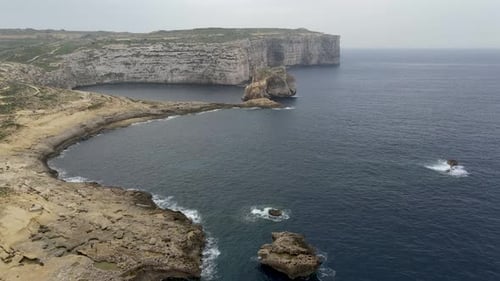 Aerial 4k drone video of The Dwejra Bay at the northwestern end of the island of Gozo, Malta. Steep