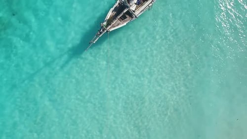 Wooden Boat Resting in Turquoise Tropical Water
