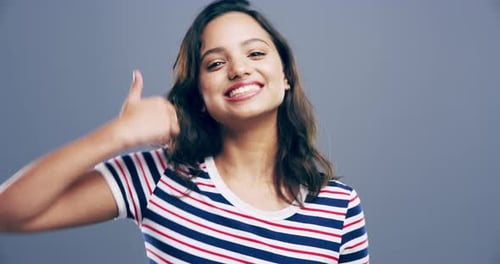 Happy Young Woman Gives Thumbs Up