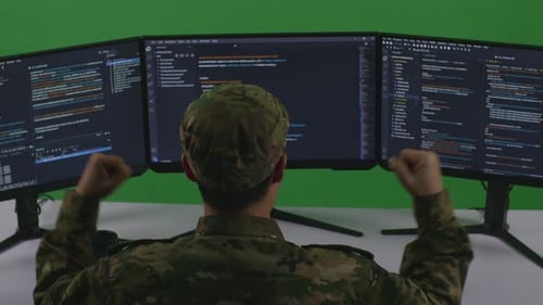 Asian Man Soldier Developer Celebrating While Write Code With Multiple Screens In Green Screen