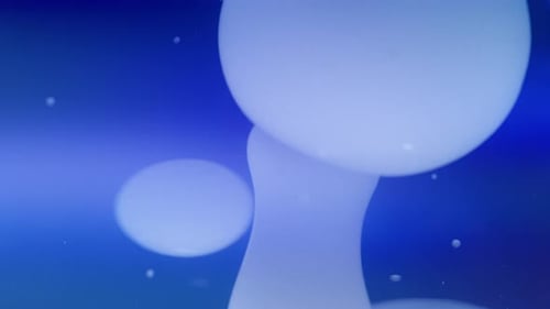 Abstract lava bubbles floating in liquid on a gradient blue background