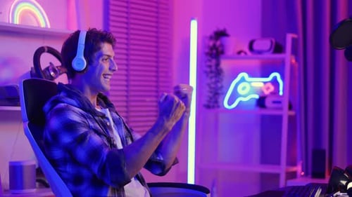 Young Adult Gaming with Neon Lighting at Home