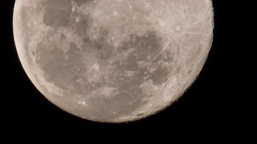 View of a full moon as it moves slowly a little upwards, showing the craters and other landforms tha