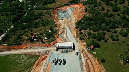 Dump Trucks At Quarrying Site On Sunny Day. aerial shot