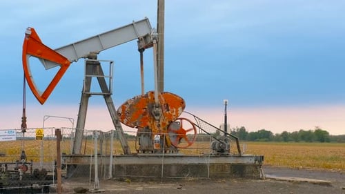 Oil Pump Working on Rural Field at Daytime