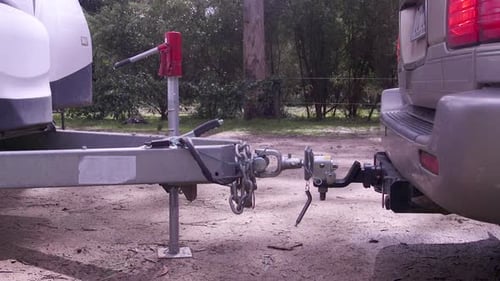 SUV Hooking Up Camper Trailer in Rural Setting