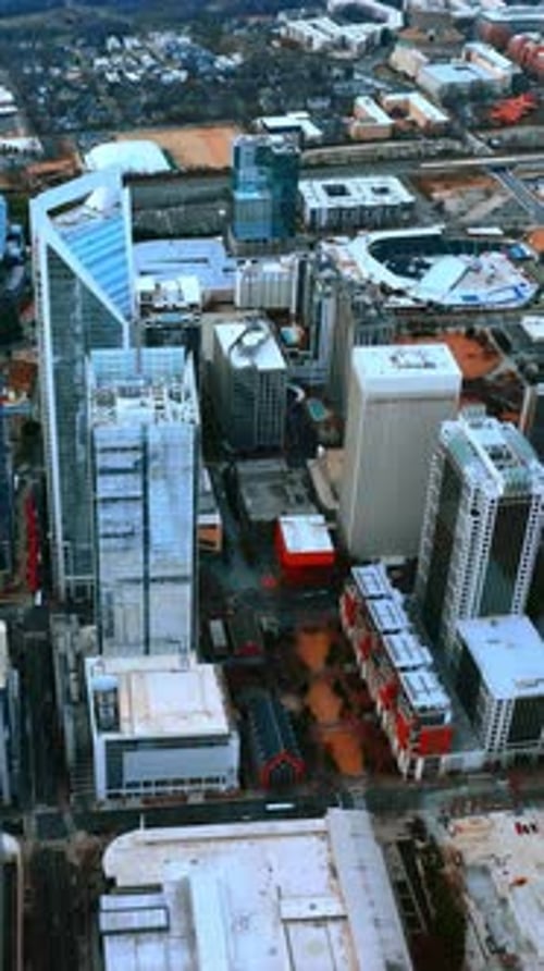 Modern skyscrapers, highways, stadium in the city uptown.