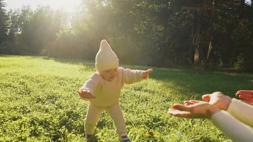 Baby Takes the First Steps Unsuccessfully Falls in Nature