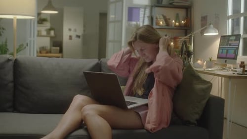 Young Adult Woman Working From Home on Laptop