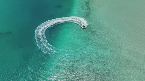 Aerial view of jet ski on turquoise water, Maldives.