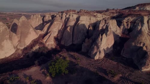 Drone view of rugged rock formations in Cappadocia at sunrise