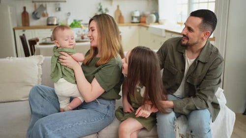 Happy Family Relaxing Together on Sofa