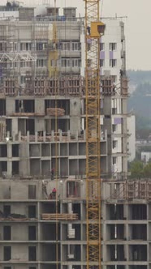 Construction Workers on Construction Site Building New Living District Telephoto