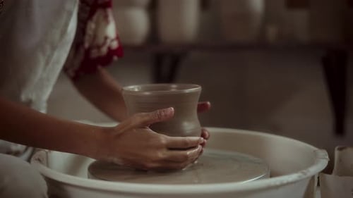 Potter Forming Clay Pot on Wheel