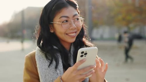 Woman Using Smartphone in Urban Setting