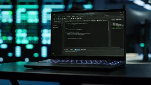 Focus on Laptop Used By Engineers Coding in Modern Data Center
