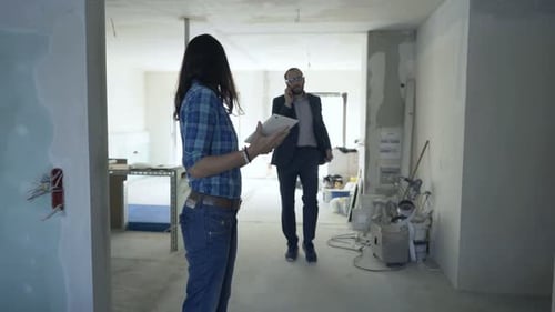 Real Estate Team Analyzing Home Plans on Tablet