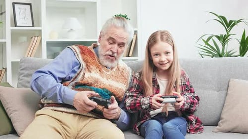 Grandfather and Grandchild Play Video Game Together