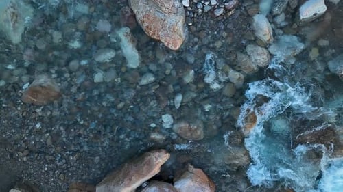 Aerial Drone Top Down View at Strong Streams of Cold Clean Water is Flowing Over Stones