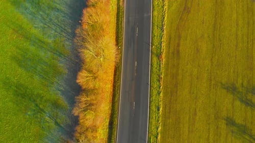 drone flight over open country road with some traffic