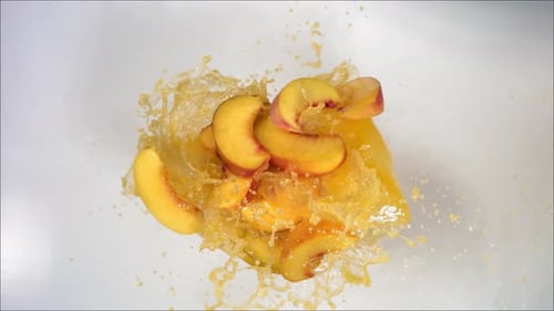 Super Slow Motion of Explosion Peach and Burst Juice and Slices