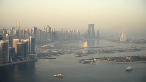 Explore the Stunning Aerial View of Dubai at Sunrise Showcasing the Cityscape and a Body of Water