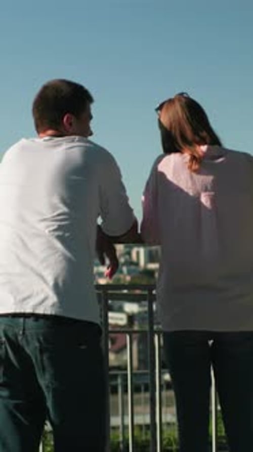 Young Couple Viewing City from High Vantage Point