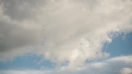 Clouds Drifting Slowly Across a Blue Sky