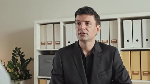 Well-Dressed Man Explaining Strategy in Modern Office