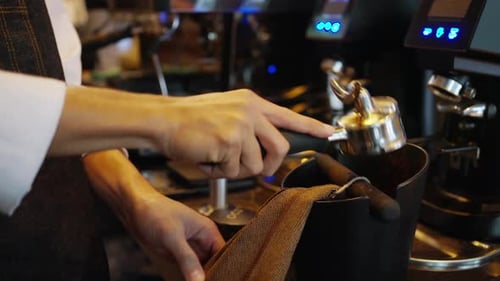 4K Barista making hot coffee on coffee maker at coffee shop.