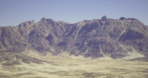 Majestic Mountain Range Under Clear Blue Sky with Expansive Valley Below