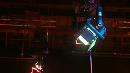 Adjusting barn doors of the professional light with a metal pipe in a television studio