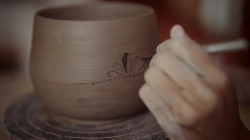 Potter Engraving Detailed Floral Pattern on Clay Pot