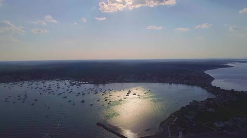 Massachusetts harbor with boats and sailboats, sunny, far away- Drone video