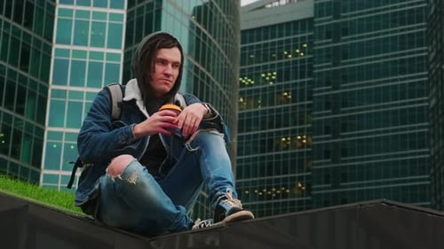 Young Adult Drinking Coffee in Urban Setting
