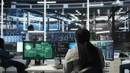 Server Farm IT Expert Responds to Security Breach Alert Displayed on PC Monitor