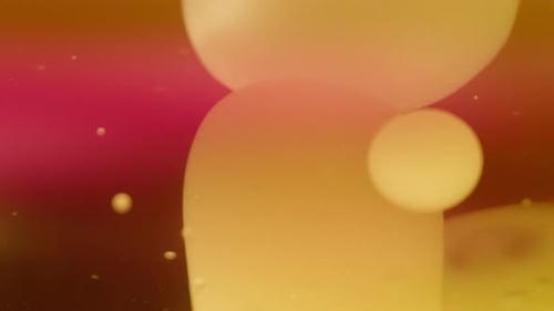 Abstract yellow lava bubbles floating in liquid on gradient red