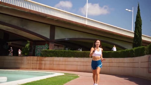 Young Woman Jogging in the City Park